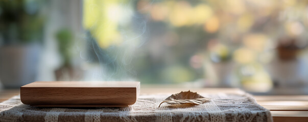 Wooden charging station on vintage tablecloth with blurred leaf in front and out-of-focus background