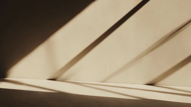 Sunlight creating warm, dramatic diagonal shadow patterns and lines on a textured beige wall and floor, reflecting natural light and an abstract aesthetic minimal background
