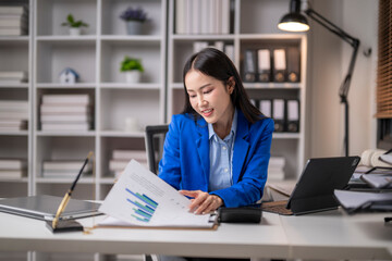 Businesswoman analyzing financial reports at desk
