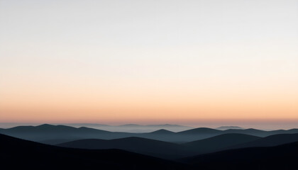 Peaceful mountain silhouettes in soft atmospheric light