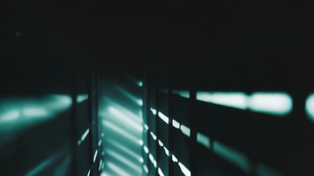 Modern architectural space featuring a receding perspective with repetitive bright light patterns along walls, creating an abstract and futuristic atmosphere