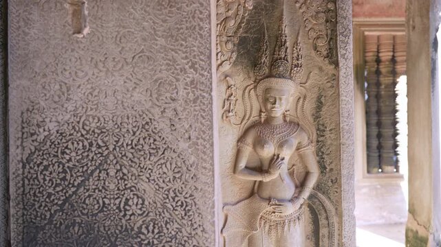 SIEM REAP, CAMBODIA - OCTOBER 27, 2025: Interior view of the ancient stone corridors and galleries within Angkor Wat. Featuring rows of weathered pillars, traditional Khmer window balusters, and the a