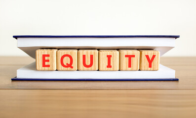 Equity support and help symbol. Concept word Equity on beautiful wooden blocks in beautiful book....