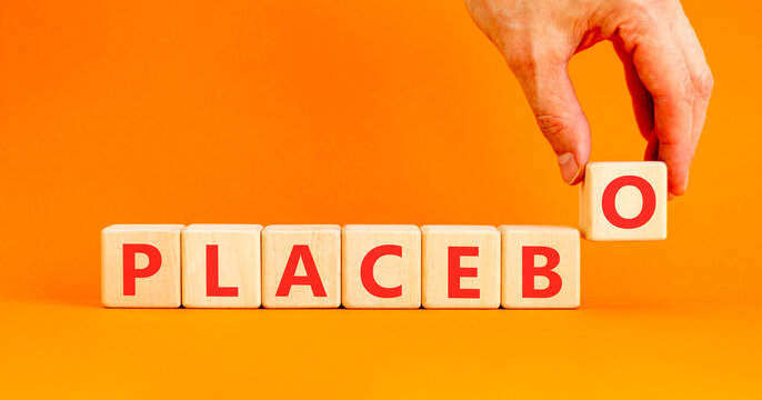 Placebo word medical symbol. Concept word Placebo on beautiful wooden blocks. Beautiful orange background. Doctor's hand. Business placebo word medical concept. Copy space.