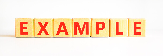 Obraz premium Example examples symbol. Concept word Example on beautiful wooden blocks. Beautiful white background. Business example examples concept. Copy space.