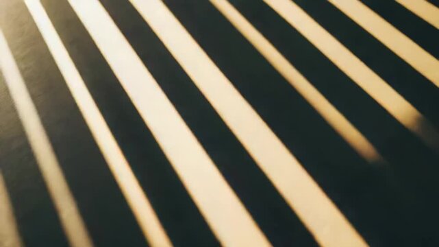 Sunlight falling in parallel stripes onto a rough, textured floor, creating striking patterns of warm light and dark shadow, symbolizing hope, emergence, and new beginnings