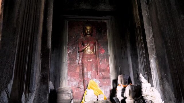 SIEM REAP, CAMBODIA - OCTOBER 27, 2025: Interior view of the ancient stone corridors and galleries within Angkor Wat. Featuring rows of weathered pillars, traditional Khmer window balusters, and the a