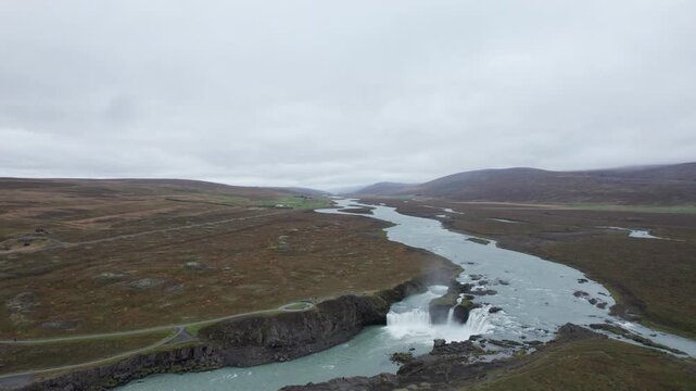 Aerial shot flying alongside Godafoss waterfall in northern Iceland