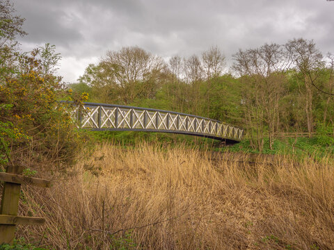 Old wooden packhorse bridge spanning the river weaver, Cheshire, UK