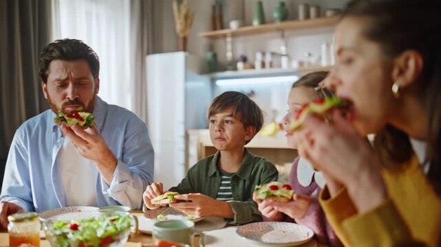 Happy family having breakfast gathering kitchen table enjoying together closeup