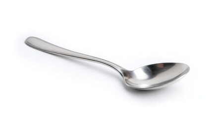 A stainless steel spoon lying on a white surface. Concept Stainless steel spoon, Minimalist still life, White surface photography, Reflective metal, Everyday object