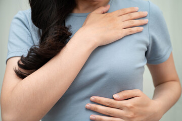 Asian woman self touching check lump or Breast cancer, Breast Self Exam.