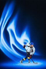 Expressive mixed media hockey player in dynamic blue energy wave. Concept of professional training, performance improvement, sports advertising, fitness motivation, and athletic branding.