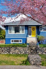 Average single family house with front yard on land terrace.