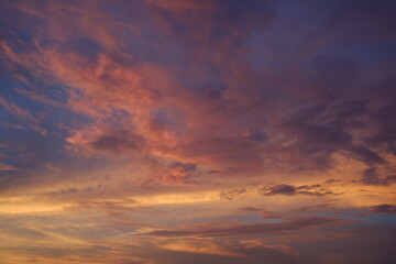 Obraz premium The twilight sky after sunset, its reddish glow burning the sky. A beautiful yet eerie abstract background.