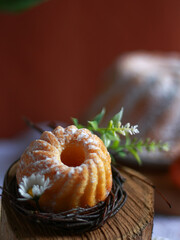 Traditional Easter cake on rustic wooden stand in soft light. Concept of minimal food styling, holiday background for banner, menu, retail marketing.
