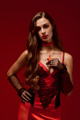 Naklejka premium Elegant lingerie model on a vibrant red backdrop for Valentine's Day