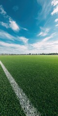 Obraz premium Expansive green soccer field under bright blue sky