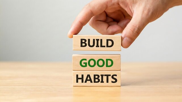 Build good habits symbol. Wooden blocks with words 'build good habits'. Male hand. Beautiful white background, copy space. Business, psychological and build good habits concept real estate concept