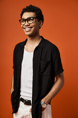 Obraz premium Handsome young man in stylish eyeglasses brings charm to vibrant studio backdrop