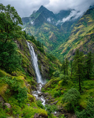Majestic Waterfall Cascading Through Lush Green Valley with Towering Mountain Backdrop