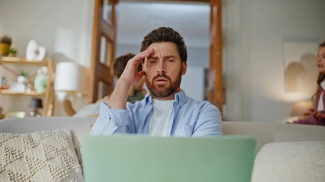 Father freelancer reacting noice sofa closeup. Shouting kids distracting father