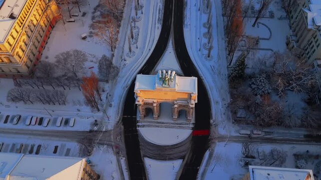 Drone shot of Siegestor Victory Gate in Germany. Famous Triumphbogen Triumphal Arch and Friedensmahnmal Peace Memorial. Cinematic winter cityscape in Bavaria near University. Luftbildvideo Muenchen