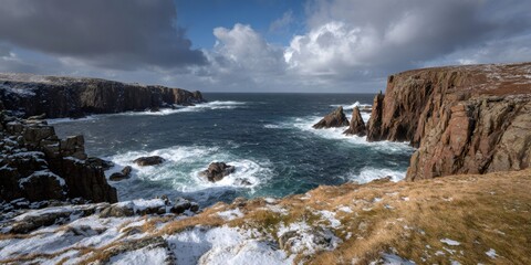 Obraz premium Scottish cliff coastline with ocean waves and winter snow