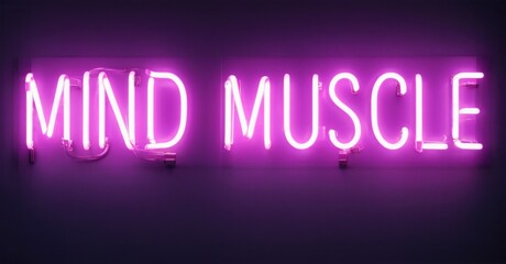Obraz premium Bright purple neon sign displays words mind muscle. Dark background emphasizes glowing text. Simple, motivational message.