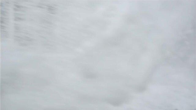 Firefighting nozzle spraying thick white foam in industrial setting during emergency response or training exercise