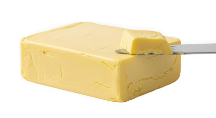 A block of butter being sliced with a knife on a white surface isolated on transparent background