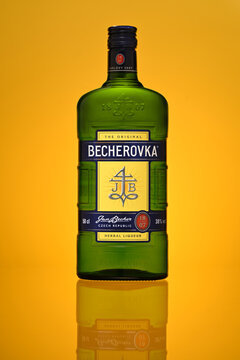 A bottle of Becherovka sits on a yellow background