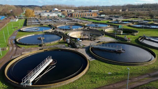 A detailed aerial perspective of a massive wastewater treatment facility located in Hoddesdon, United Kingdom.