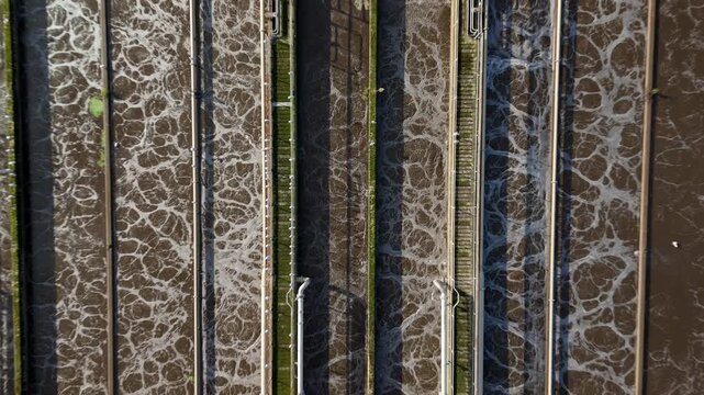 Top down aerial view of sewage settling aeration tanks basins, activated sludge process to remove solid matter through aerobic digestion in the UK