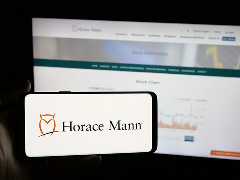 Stuttgart, Germany - 01-16-2026: Person holding smartphone with logo of US company Horace Mann Educators Corporation on screen in front of website. Focus on phone display.