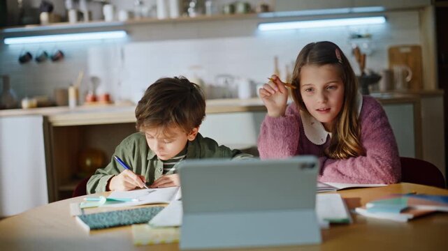 School kids watching tab computer studying online apartment workplace closeup