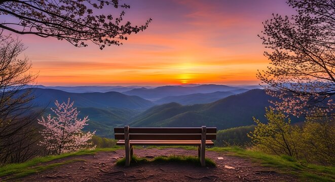 A serene bench overlooking a breathtaking mountain landscape at sunset