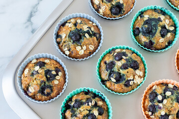 Blueberry muffins with oatmeal in a baking pan. Top view. Sweet homemade breakfast or snack food.