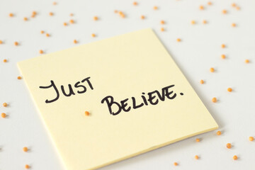 Just believe, inspirational Christian quote with mustard seeds on white background. Close-up. Trust...
