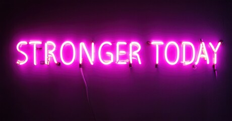 Obraz premium Bright pink neon sign displays positive message. Dark background emphasizes glowing text, creating bold visual impact. Simple, motivational design.