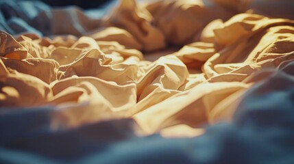 Warm sunlight on crumpled beige bed sheets, cozy morning bedroom scene, soft texture and relaxing lifestyle mood.
