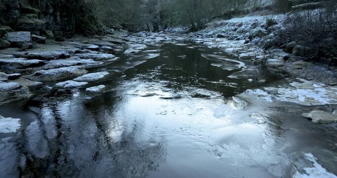 Flying over frosty river in Swaledale