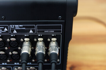 Naklejka premium Close Up of XLR Cables Connected to Digital Audio Mixing Console Rear Panel