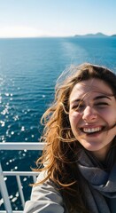 Fototapeta premium A woman enjoying the scenery of the beautiful sea while taking a selfie