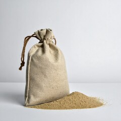 A small, beige drawstring pouch stands upright next to a pile of golden-brown granular substance, all against a white backdrop