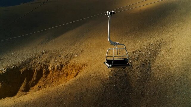 Ski lift chairs dangling over exposed dirt and rocks, barren winter mountain, 8K cinematic, 2026