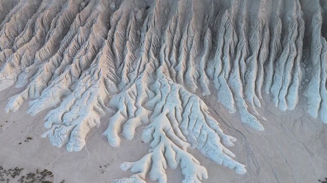 Aerial view of the stark white Tuzbair chalk cliffs revealing intricate patterns carved by erosion, showcasing nature's artwork, Tuzbair, Mangystau Region, Kazakhstan.