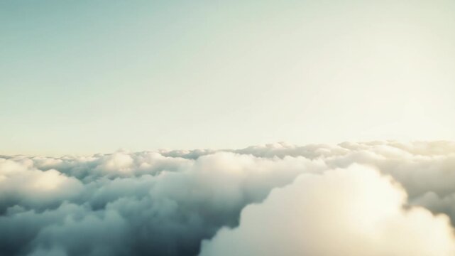Fluffy cumulus clouds form a soft, ethereal layer beneath a vast clear blue sky, evoking serene calm, airy openness and peaceful, dreamy atmospheric beauty
