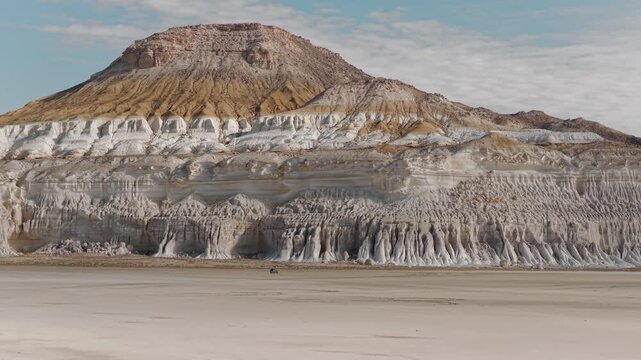 Aerial view of the striking Tuzbair sor with its layered cliffs and arid landscape, creating a mesmerizing contrast of colors and textures, Tuzbair, Mangystau Region, Kazakhstan.