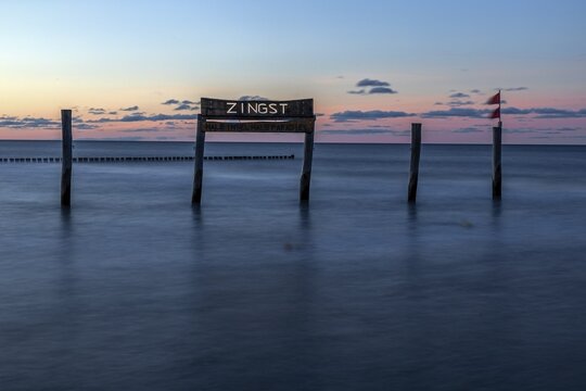 Wooden sign in the sea with inscription Zingst, long exposure, evening light, Zingst, Fischland-Dar&szlig;-Zingst, Vorpommersche Boddenlandschaft National Park, Mecklenburg-Western Pomerania, Germany